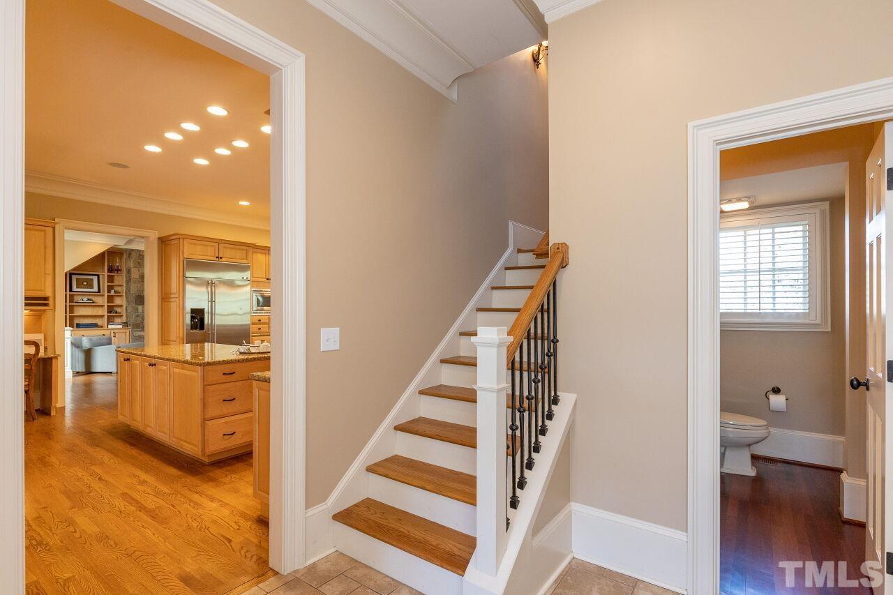 1914 Lewis Circle Raleigh, NC 27608 - Photo 19 of 55 a view of a hallway with wooden floor and staircase