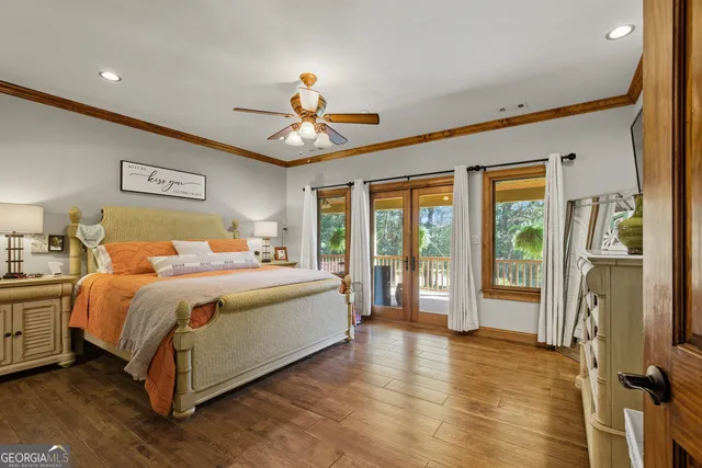 a spacious bedroom with a large bed and a chandelier