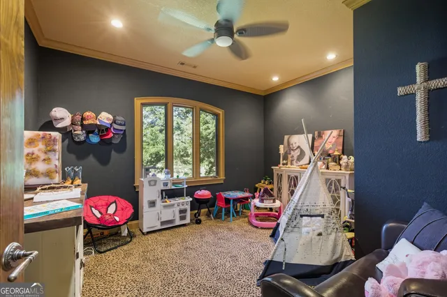 a bedroom with furniture and a flat screen tv