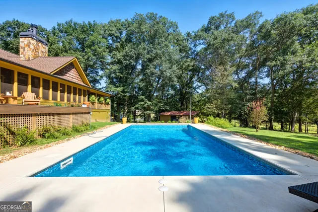 a view of house with yard and green space