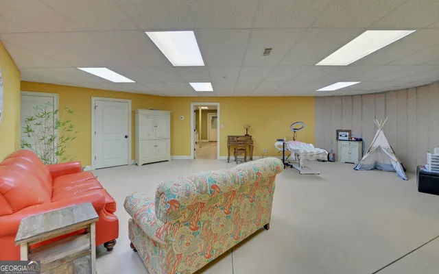 a bedroom with a bed and a wall painting