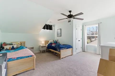 a living room with furniture and a baby crib