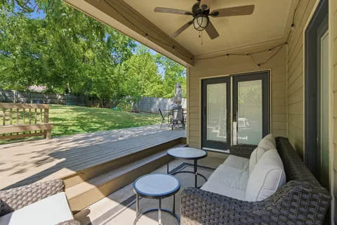 a view of a porch with furniture and a yard