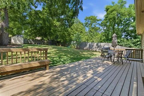 a view of a deck with wooden floor and fence