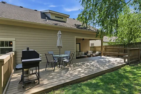 a view of a backyard with table and chairs