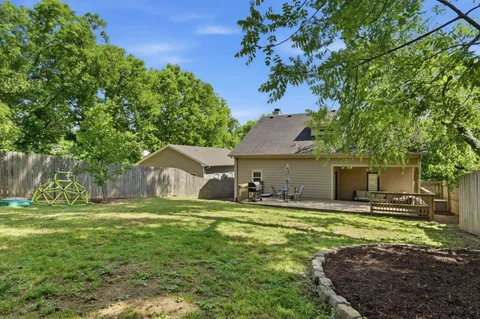 a house view with a sitting space and garden