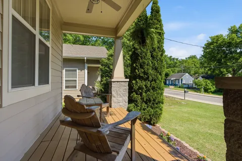 a view of house with backyard outdoor seating and hardwood