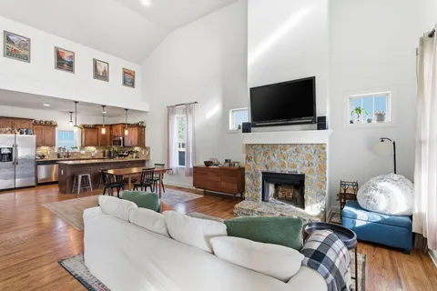 a living room with furniture a flat screen tv and a fireplace