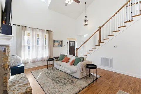 a living room with furniture and wooden floor