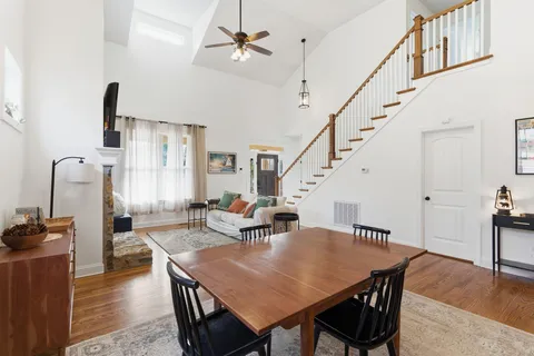 a dining room with furniture and wooden floor