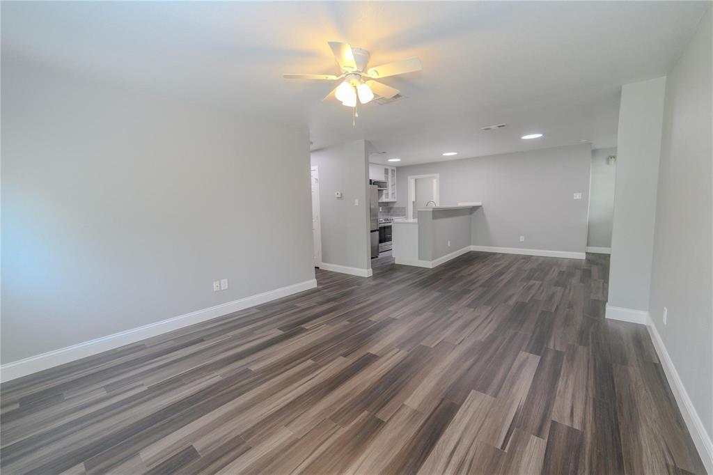 809 Wilcox Street McKinney, TX 75069 - Photo 2 of 26 Unfurnished living room featuring ceiling fan, dark wood-style floors, and recessed lighting