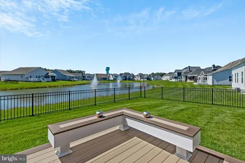 a front view of a residential houses with yard and green space
