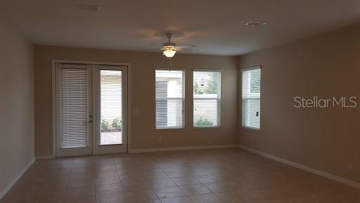 7652 Ripplepointe Way Windermere, FL 34786 - Photo 4 of 21 a view of an empty room with a window and wooden floor