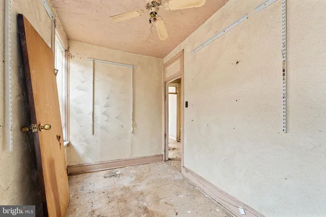 a view of a livingroom with a ceiling fan and window