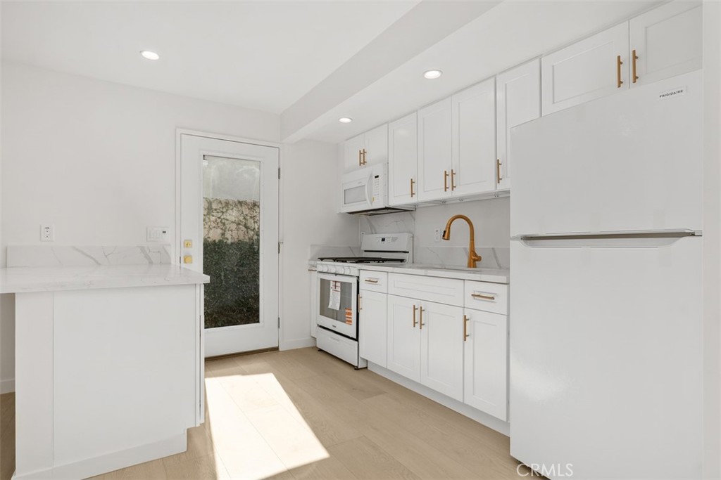 3926 Acacia Street Irvine, CA 92606 - Photo 18 of 32 a kitchen with cabinets appliances a sink and a counter top space