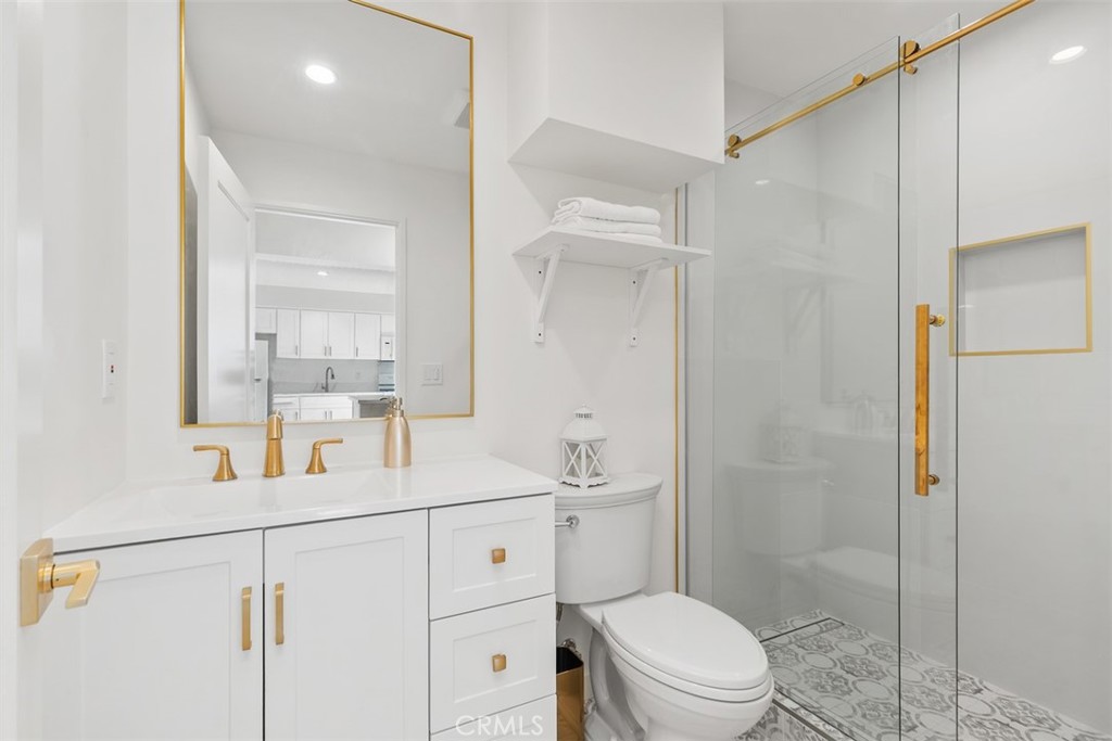 3926 Acacia Street Irvine, CA 92606 - Photo 19 of 32 a bathroom with a sink a toilet a shower and a mirror