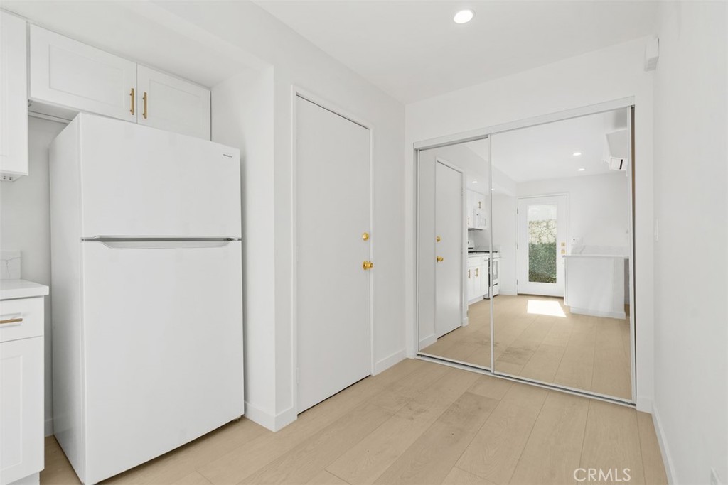 3926 Acacia Street Irvine, CA 92606 - Photo 6 of 32 a view of a kitchen with a closet and a refrigerator