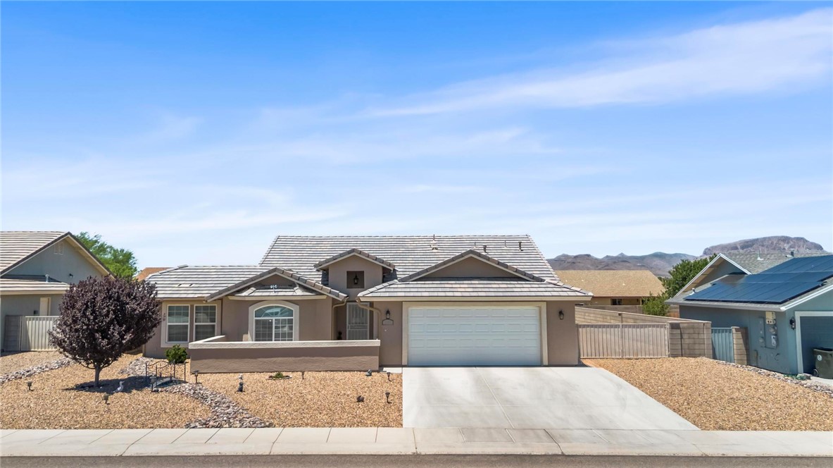 3897 Easy Street Kingman, AZ 86409 - Photo 1 of 53 a front view of a house with a yard