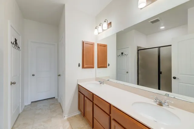 a bathroom with a sink double vanity and a mirror