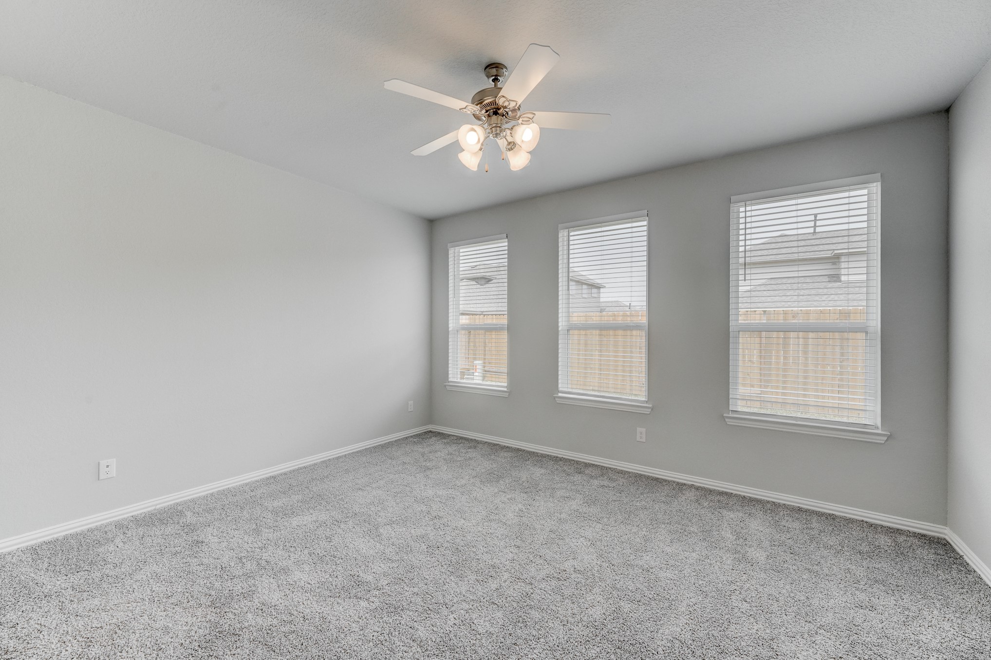 1229 Red Hills Drive Rosharon, TX 77583 - Photo 12 of 29 an empty room with chandelier fan and windows