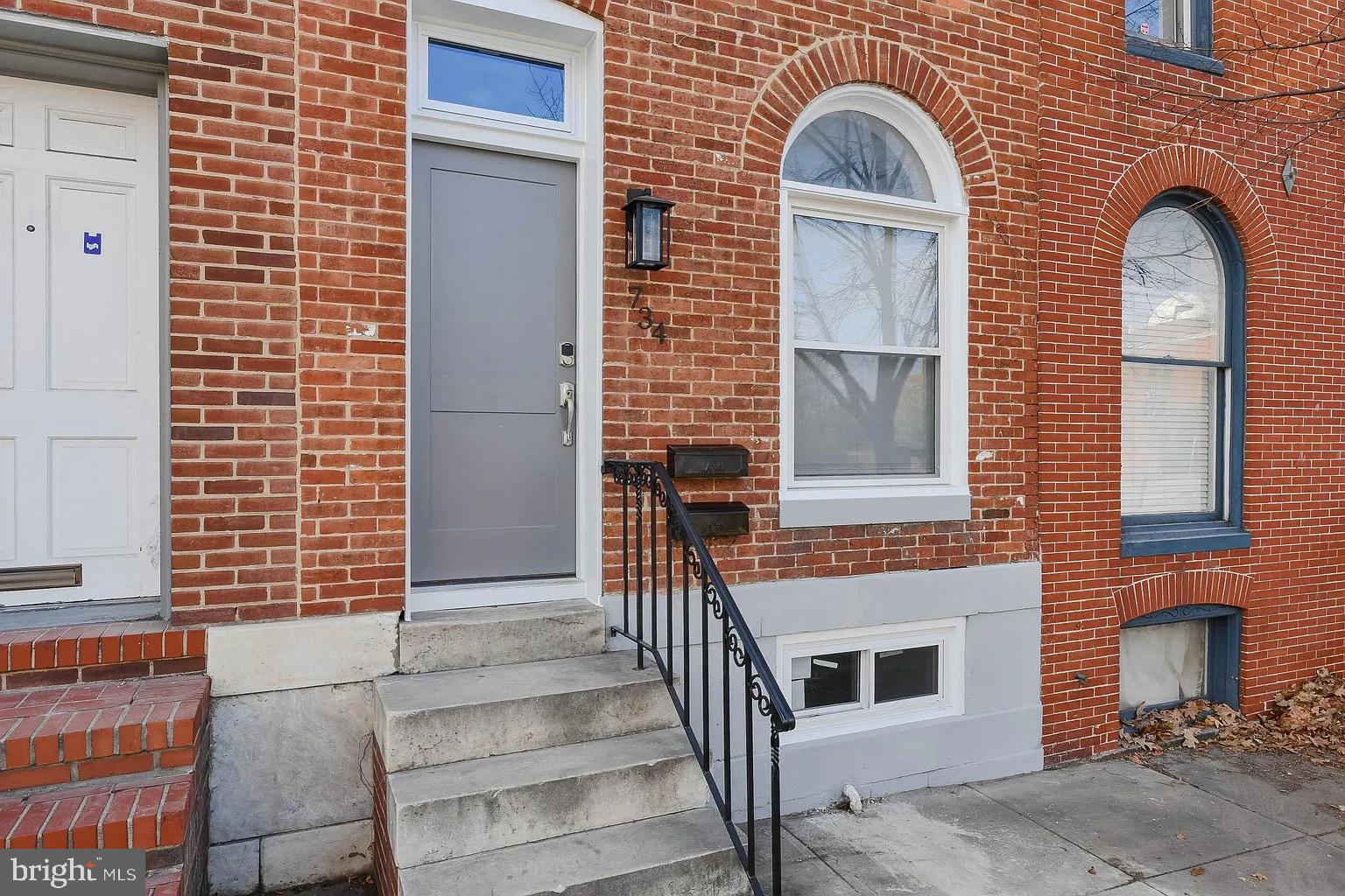 a view of a brick house with large windows