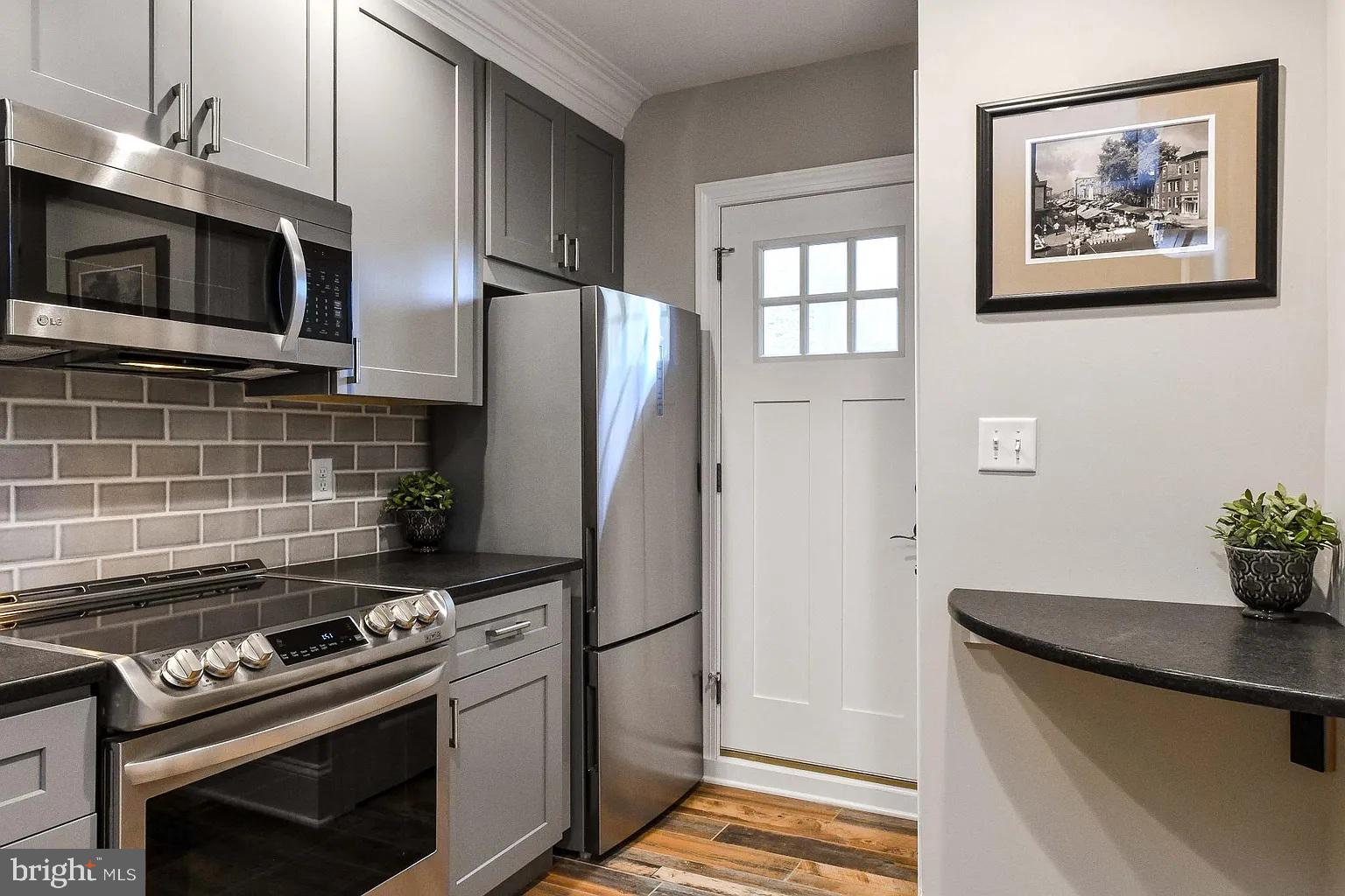 734 Light Street, Unit 1 Baltimore, MD 21230 - Photo 3 of 6 a kitchen with stainless steel appliances and microwave