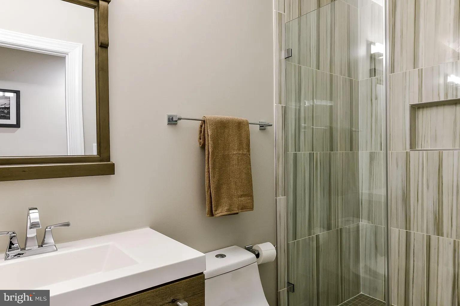 734 Light Street, Unit 1 Baltimore, MD 21230 - Photo 5 of 6 a bathroom with a sink a toilet and shower