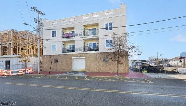 a view of a building and a cars parked on the road
