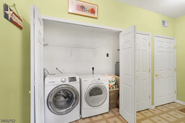 a kitchen with stainless steel appliances granite countertop a stove top oven a sink dishwasher a dining table and chairs with wooden floor