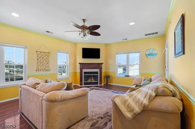 a living room with fireplace furniture and a flat screen tv