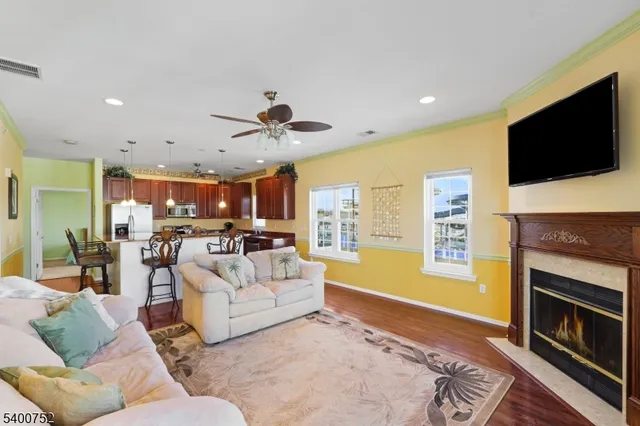 a living room with furniture a fireplace and a flat screen tv