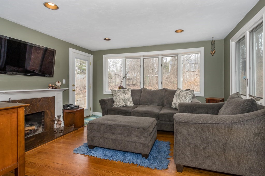 14 Kings Road Canton, MA 02021 - Photo 12 of 23 a living room with furniture a flat screen tv and a fireplace