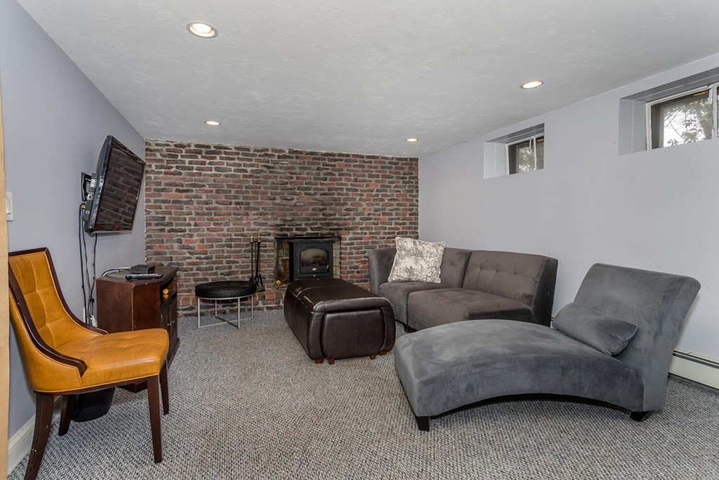 14 Kings Road Canton, MA 02021 - Photo 20 of 23 a living room with furniture a fireplace and a flat screen tv