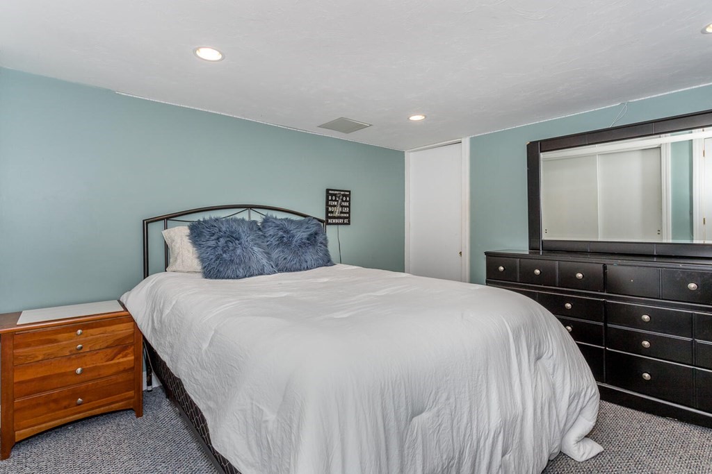 14 Kings Road Canton, MA 02021 - Photo 22 of 23 a bedroom with a bed and a flat tv screen on dresser