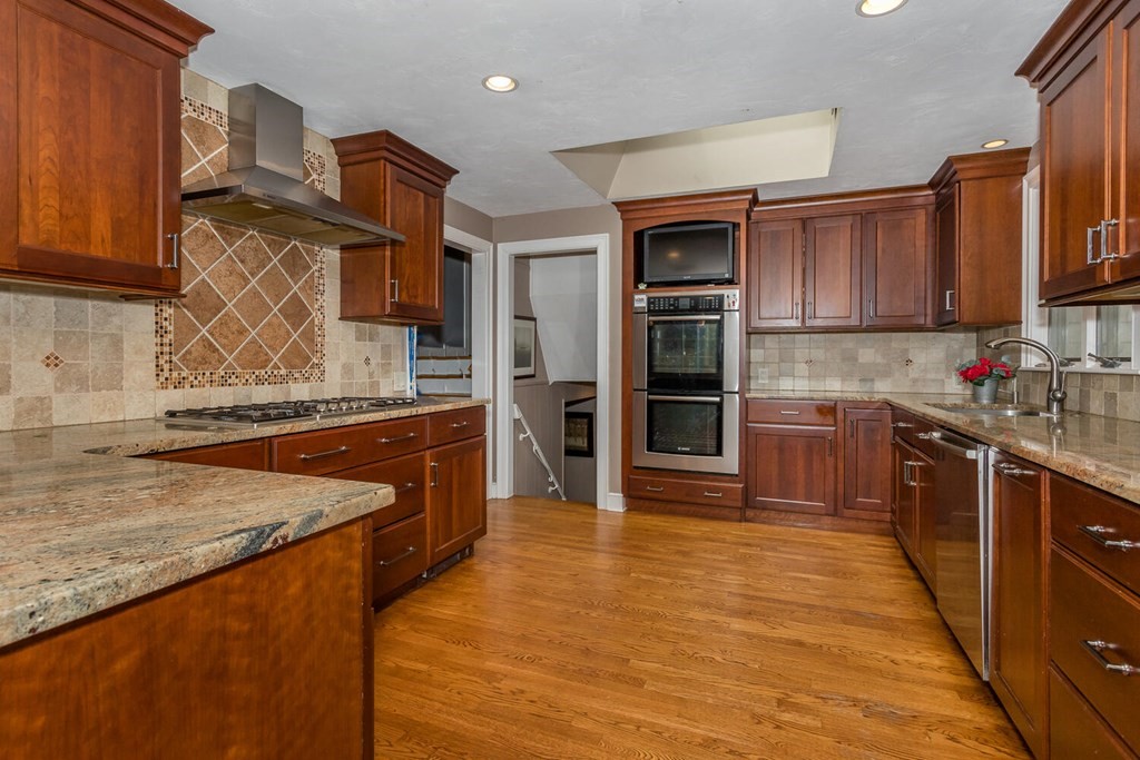 14 Kings Road Canton, MA 02021 - Photo 9 of 23 a kitchen with stainless steel appliances granite countertop a stove a sink and a refrigerator