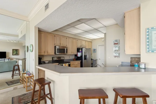 a kitchen with a table chairs refrigerator and a sink