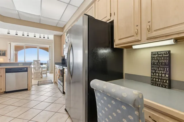 a kitchen with granite countertop a refrigerator and a stove
