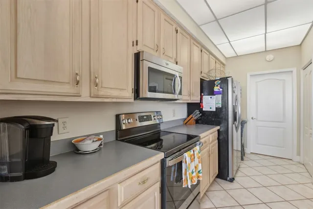 a kitchen with stainless steel appliances granite countertop a stove a refrigerator and a microwave