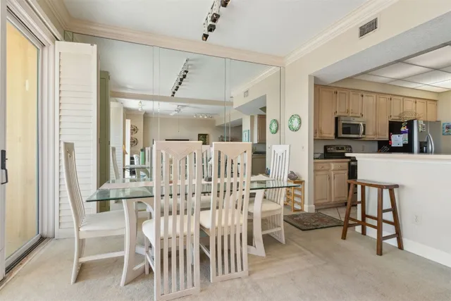 a view of a dining room with furniture and a chandelier
