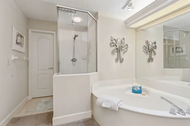 a bathroom with a tub sink and mirror