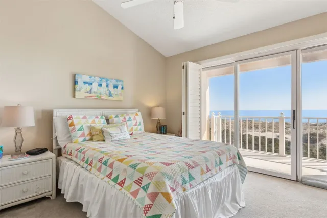 a bedroom with a bed and a flat tv screen on dresser
