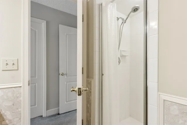 a view of a balcony with table and chairs and wooden fence