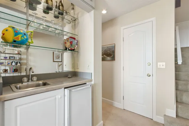 a bathroom with a granite countertop shower a sink and a mirror