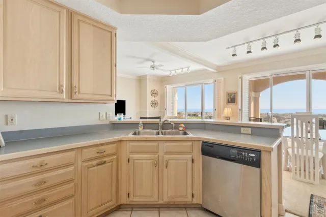 a kitchen with white cabinets and sink