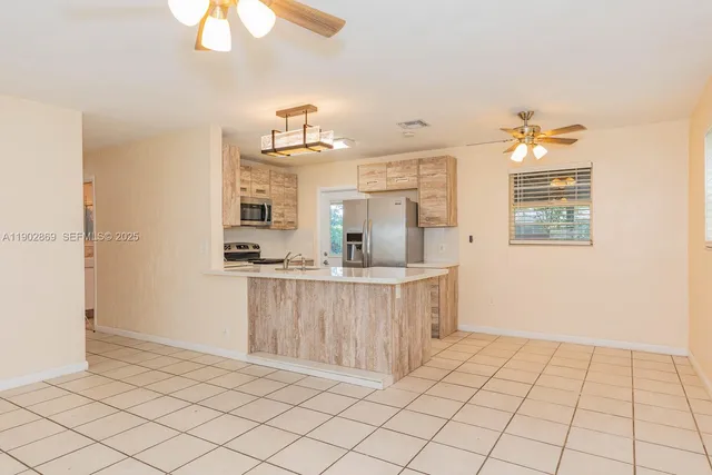 a view of kitchen with furniture wooden floor and window