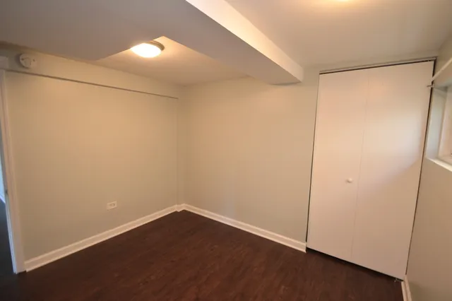an empty room with wooden floor