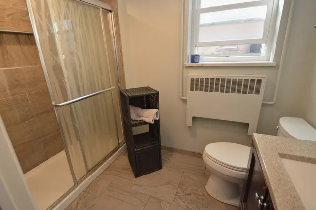a bathroom with a toilet and a shower curtain
