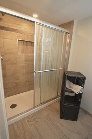 a bathroom with a shower and a mirror