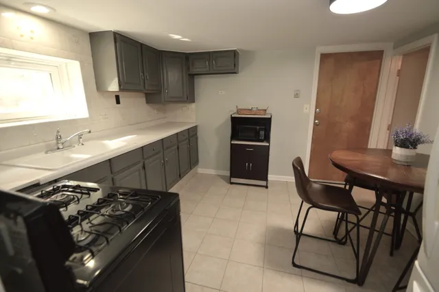 a kitchen with a stove a sink and a refrigerator