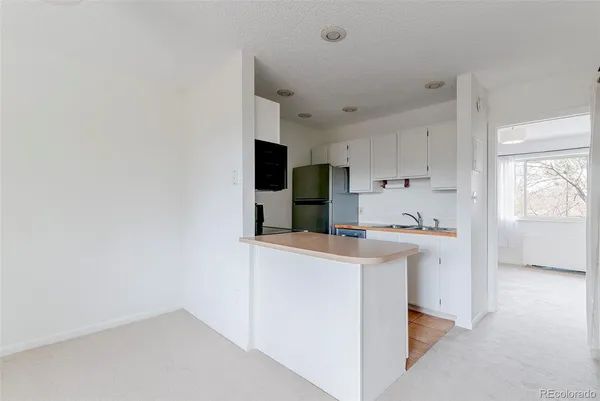 a kitchen with stainless steel appliances a refrigerator and a stove top oven